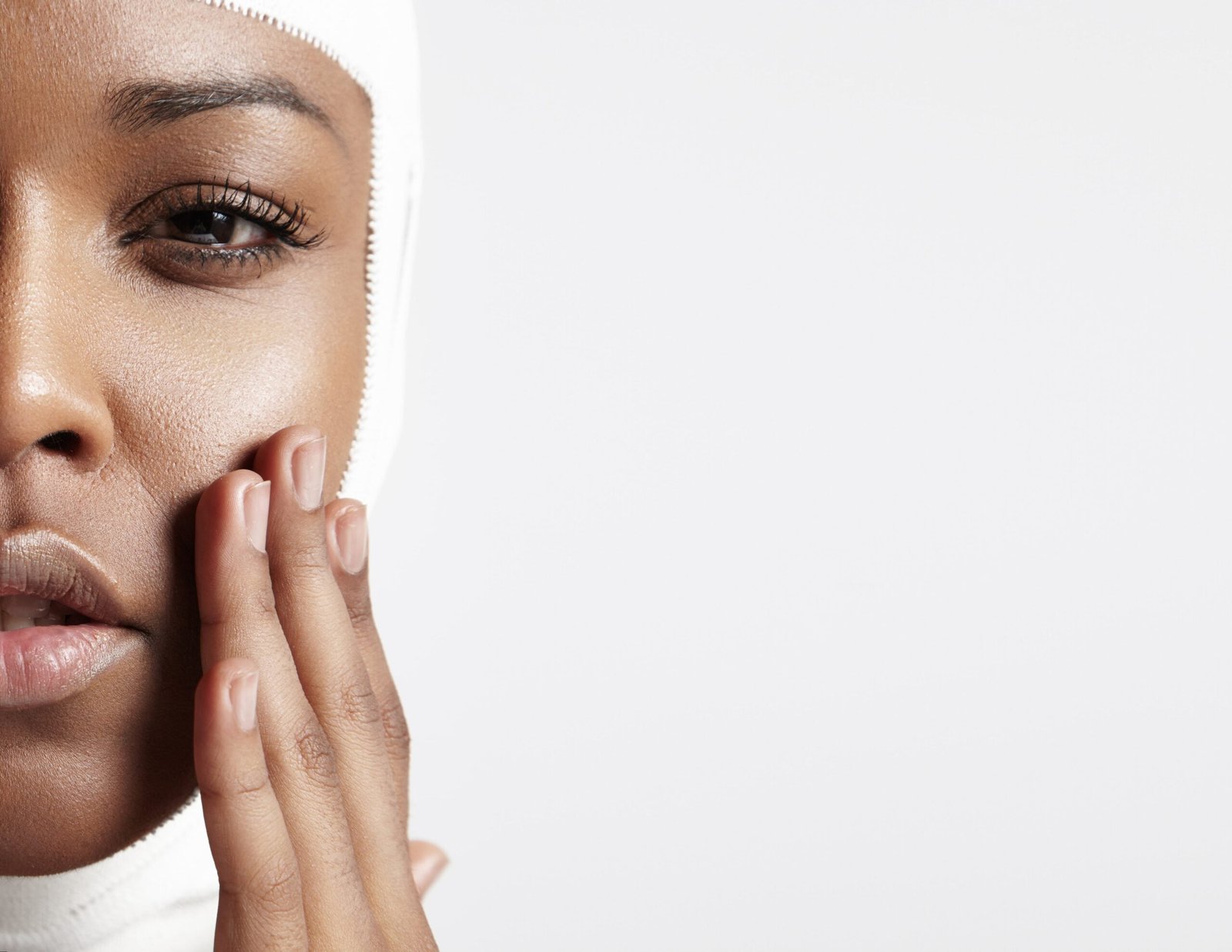 half-face-black-woman-with-bandaged-head-closeup-min